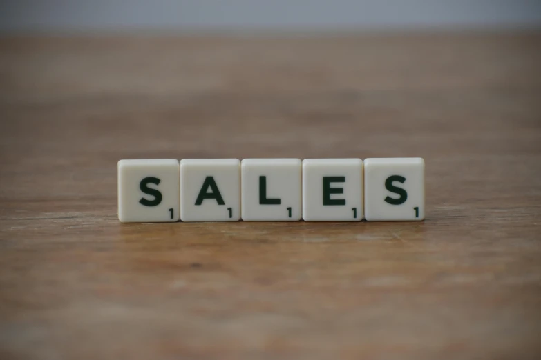 the word sales spelled in scrabbles on a wooden table, pexels, hyperrealism, square, 9, white, brown