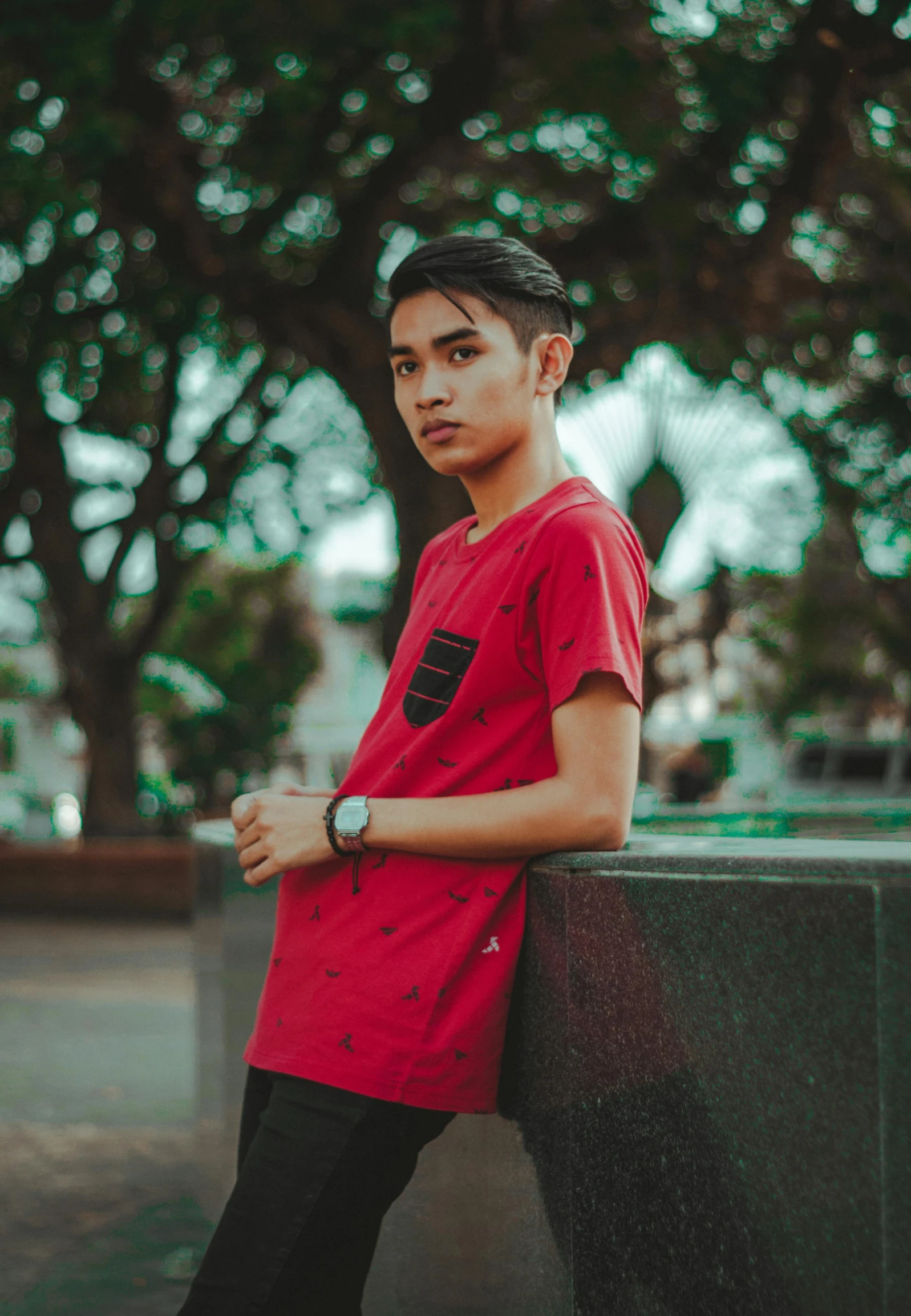 a young man in a red shirt leaning against a wall, inspired by Rudy Siswanto, pexels contest winner, hurufiyya, outlive streetwear collection, profile picture 1024px, avatar image, scenary