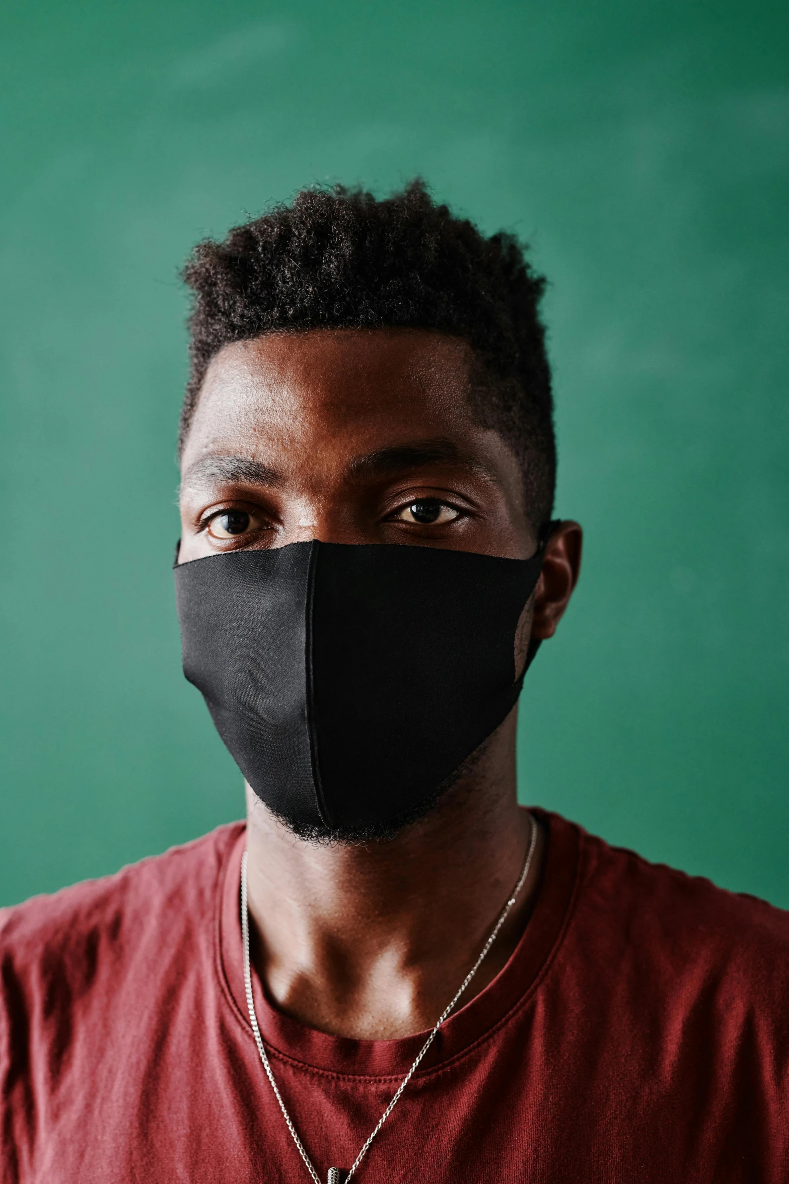a man wearing a face mask in front of a blackboard, by Carey Morris, trending on pexels, jaylen brown, portrait close up of guy, to protect us, cover story