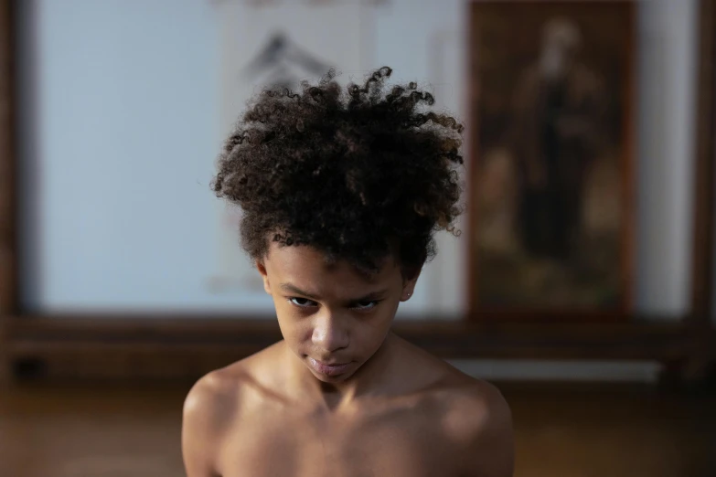 a close up of a person on a cell phone, an album cover, by Daniel Seghers, pexels contest winner, hyperrealism, boy hair, loin cloth, in a museum, light-brown skin