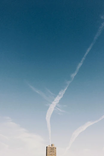 a man flying a kite on top of a lush green field, by Peter Churcher, pexels contest winner, postminimalism, contrails, white and blue, profile image, thick white detailed smoke