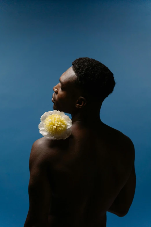 a man with a flower in his hair, an album cover, inspired by Robert Mapplethorpe, unsplash, ( ( dark skin ) ), summer sky, yasuke 5 0 0 px models, innocence