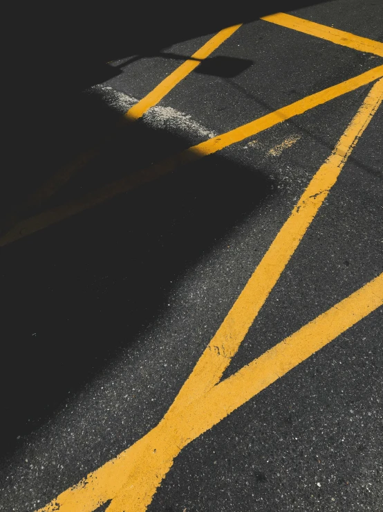 a fire hydrant sitting in the middle of a parking lot, an album cover, trending on pexels, postminimalism, black and yellow scheme, diagonal lines, long shadow, black background pinterest