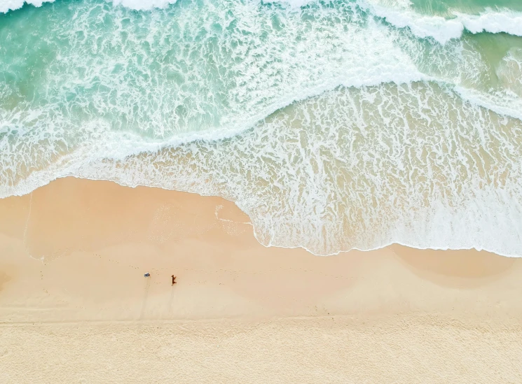 a couple of people standing on top of a sandy beach, pexels contest winner, minimalism, gold coast australia, birds eye, large waves, laying on a beach