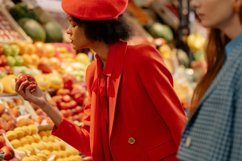 a woman in a red hat standing in front of a fruit stand, pexels, fine art, red coat, checking her phone, ashteroth, inside a supermarket