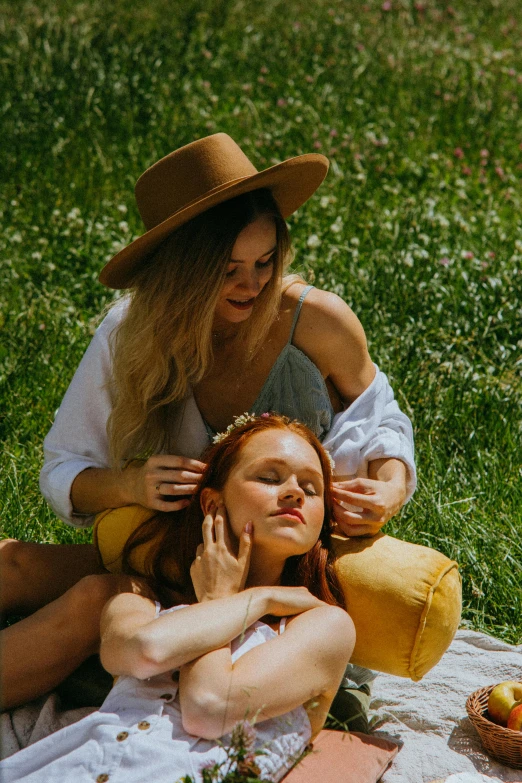 a couple of women sitting on top of a lush green field, by Niko Henrichon, trending on pexels, renaissance, ginger hair, sunbathed skin, touching heads, skincare