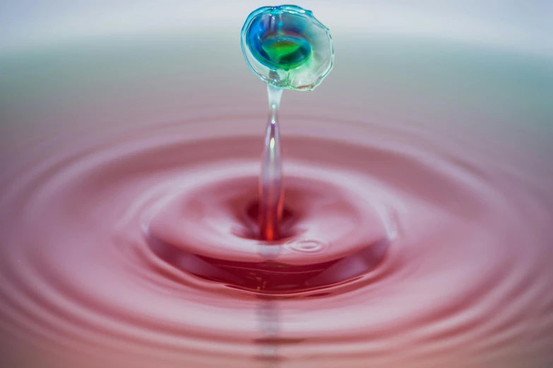 a water drop falling into a body of water, by Jan Rustem, trending on unsplash, process art, mauve and cinnabar and cyan, avatar image, physics splashes of colors, whorl