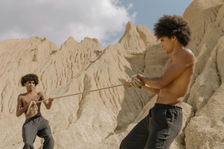 a couple of men that are standing in the dirt, fighting scene, pulling strings, ashteroth, still from a fantasy movie