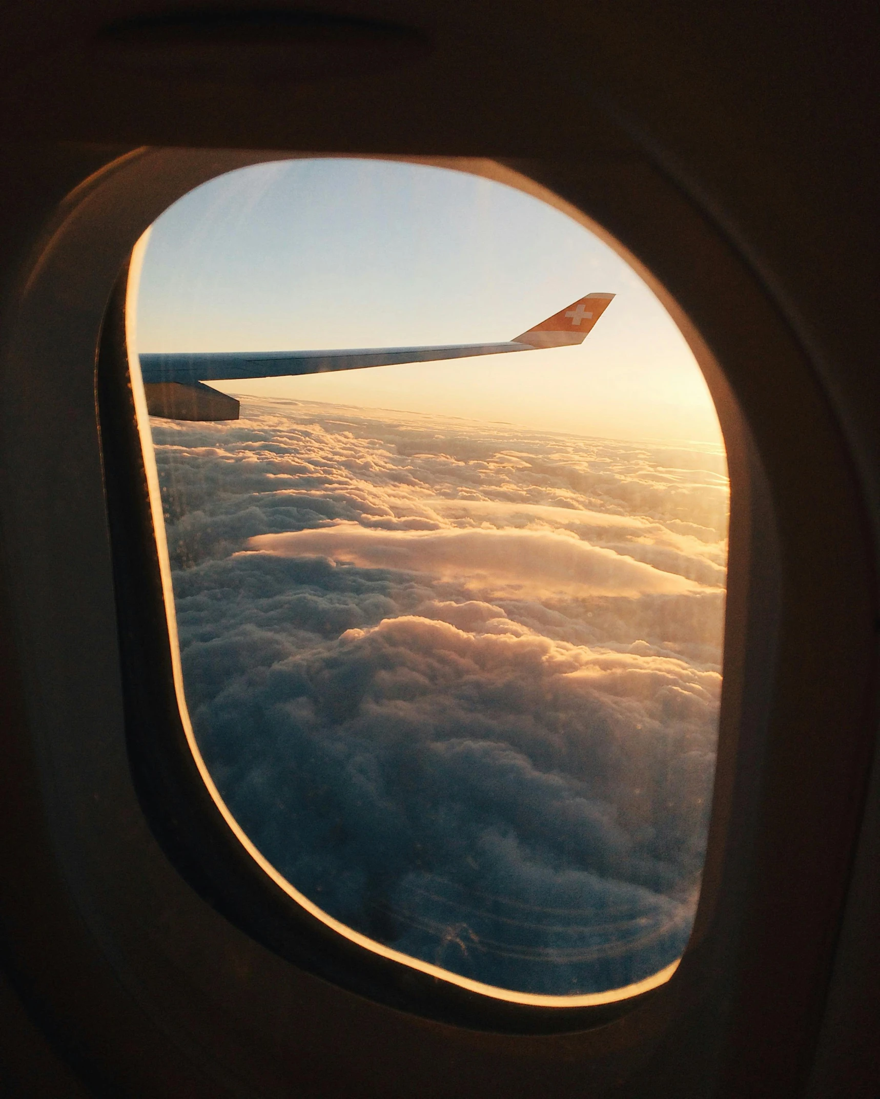 a view of the sky through an airplane window, pexels contest winner, sitting on a window sill, in suitcase, floating lands in-clouds, waving