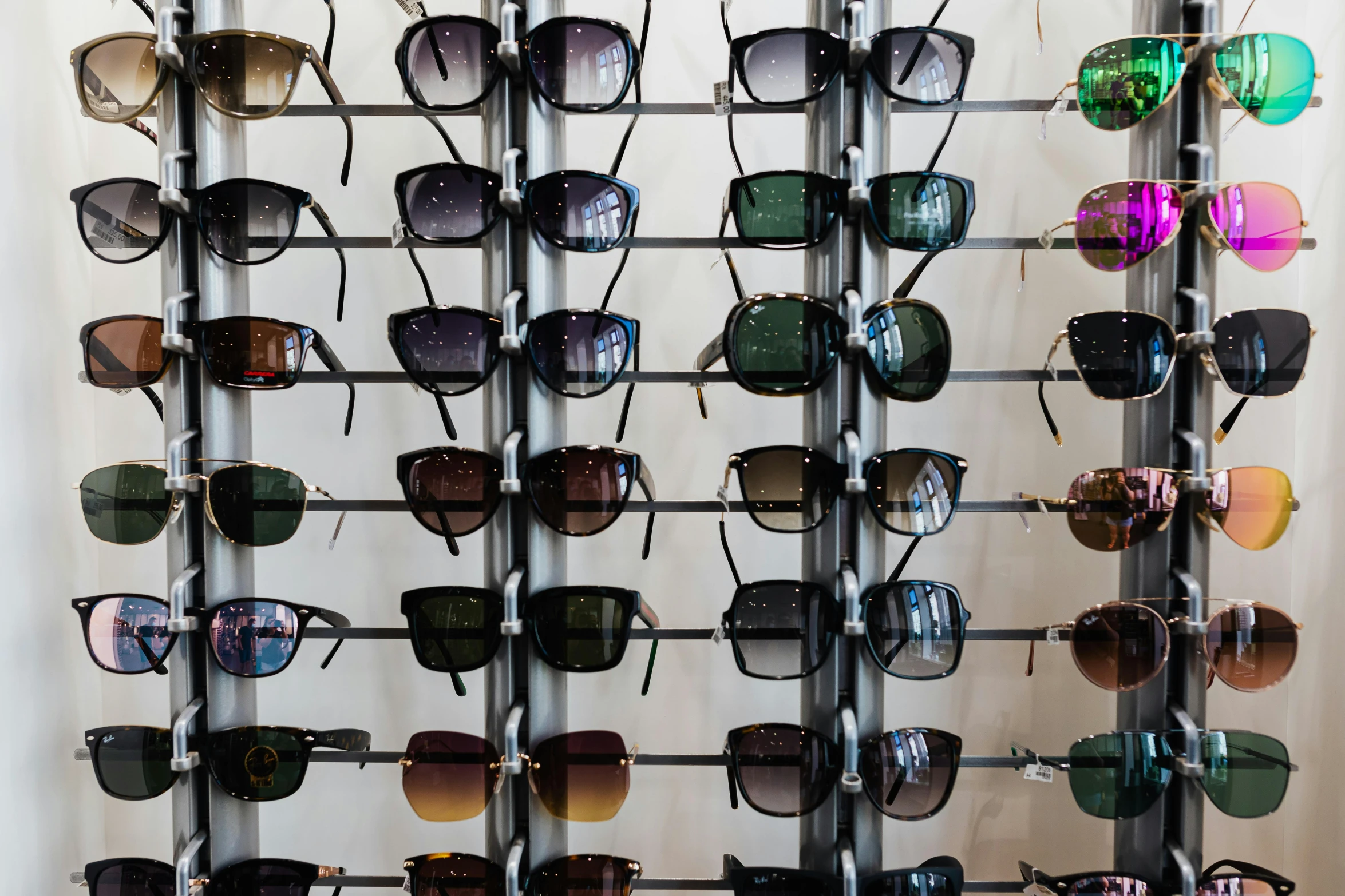 a rack that has many pairs of sunglasses on it, unsplash, square rimmed glasses, optimus sun orientation, high-quality photo, 5 7 9