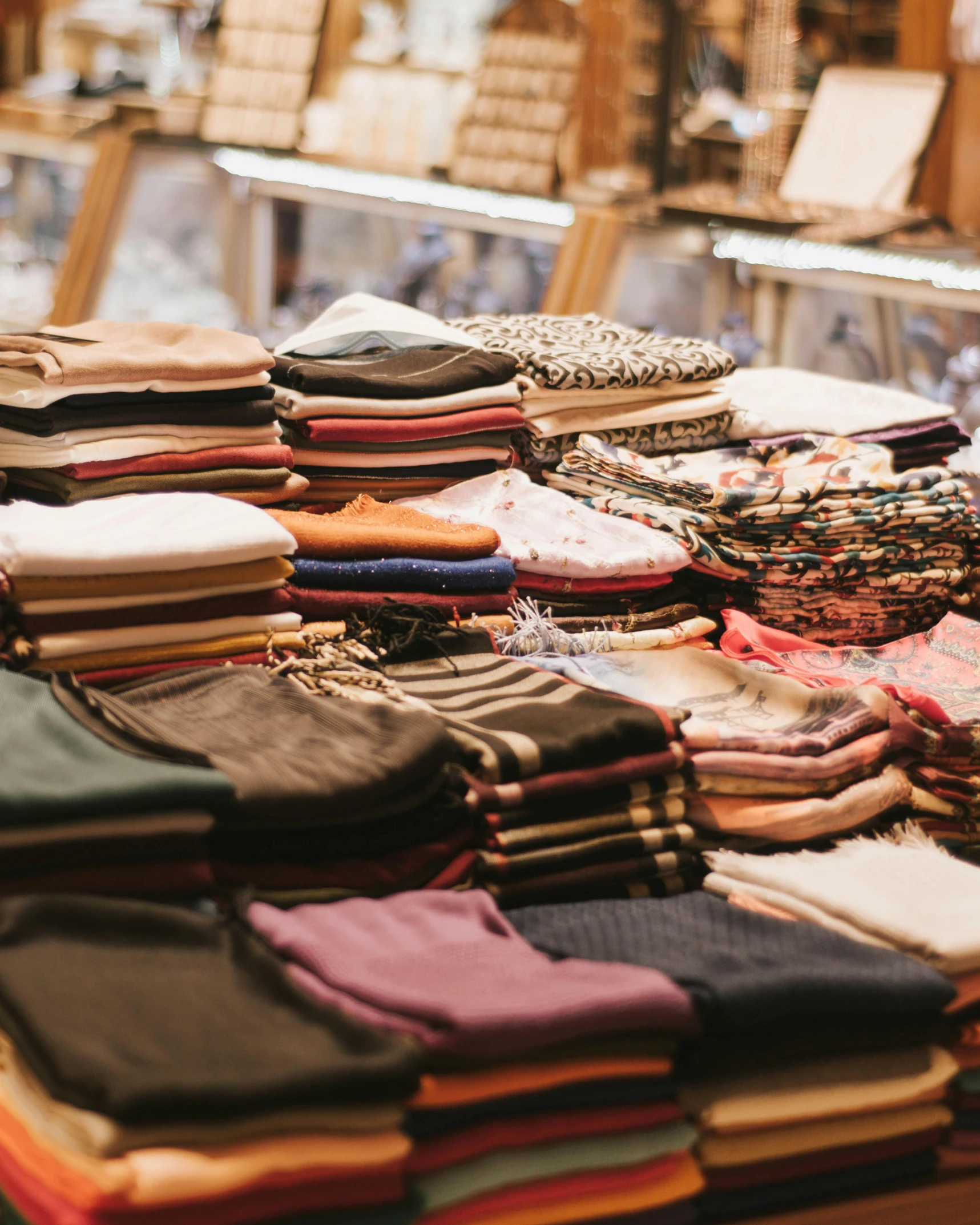 a table topped with lots of different types of clothing, by Matija Jama, trending on unsplash, stacking supermarket shelves, pouches, inside an arabian market bazaar, squares