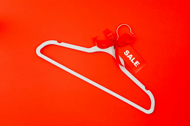 a white hanger with a sale tag on a red background, pexels contest winner, minimalism, 🎀 🗡 🍓 🧚, red and white neon, fancy dressing, greedy