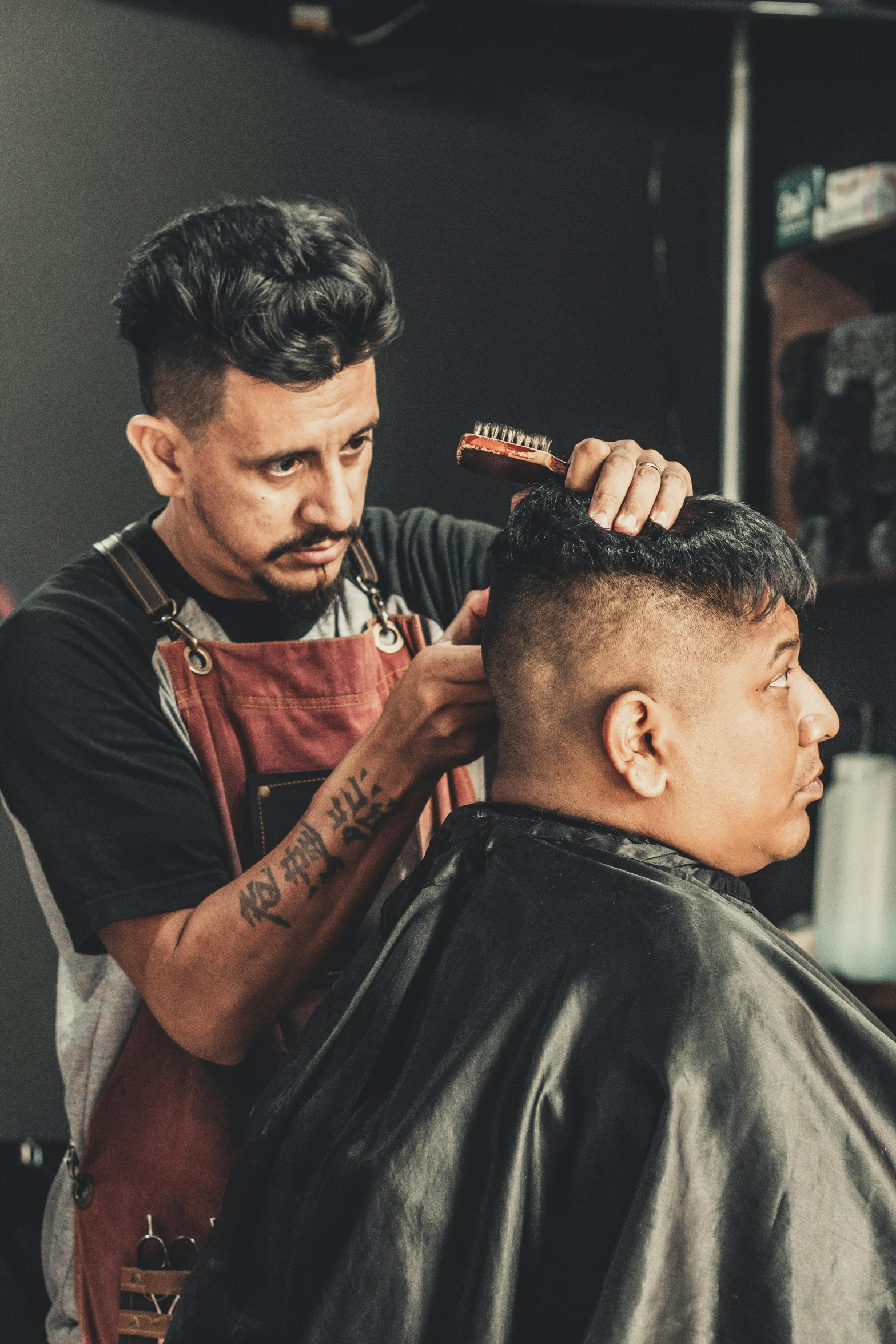 a man getting his hair cut at a barber shop, a portrait, inspired by Eddie Mendoza, trending on pexels, non-binary, chilean, profile image, studio photo