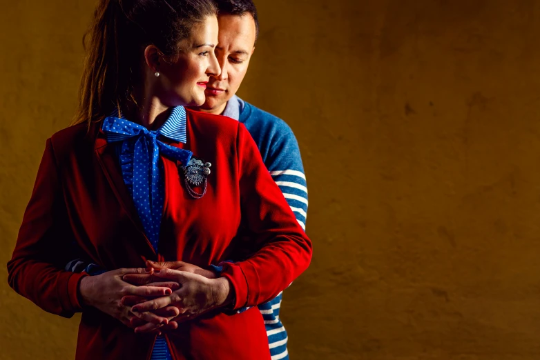 a man and a woman standing next to each other, a portrait, by Julia Pishtar, unsplash, red and blue garments, lesbian embrace, girl wearing uniform, orazio gentileschi style