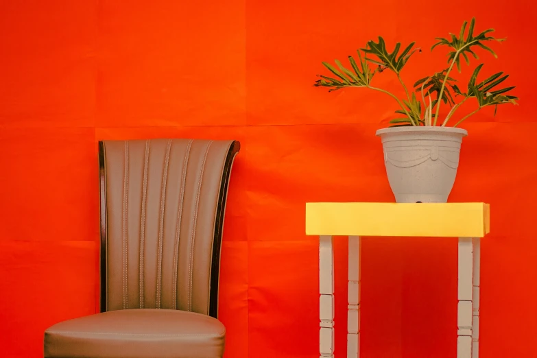 a chair next to a table with a potted plant on it, inspired by Christo, pexels contest winner, postminimalism, orange skin, intense colours, smooth panelling, payne's grey and venetian red