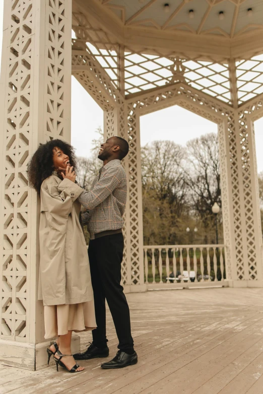 a man and woman standing in front of a gazebo, pexels contest winner, visual art, beautiful city black woman only, flirting, tall arches, fashionable