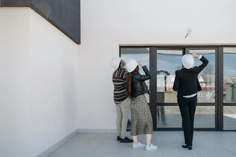 a couple of women standing in front of a building, a cartoon, inspired by Leandro Erlich, unsplash, conceptual art, white walls, inspect in inventory image, rooftop party, 3 heads