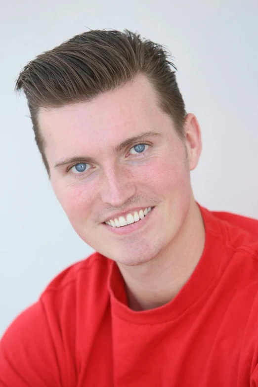 a man in a red shirt posing for a picture, liam brazier, headshot photograph, paul carrick, uploaded