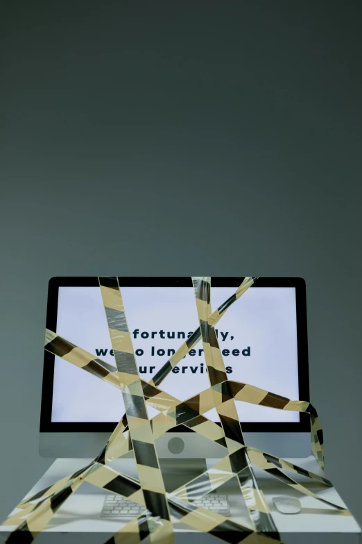 a laptop computer sitting on top of a table, an abstract sculpture, inspired by Cerith Wyn Evans, police tape, ( ( photograph ) ), forgiveness, ilustration