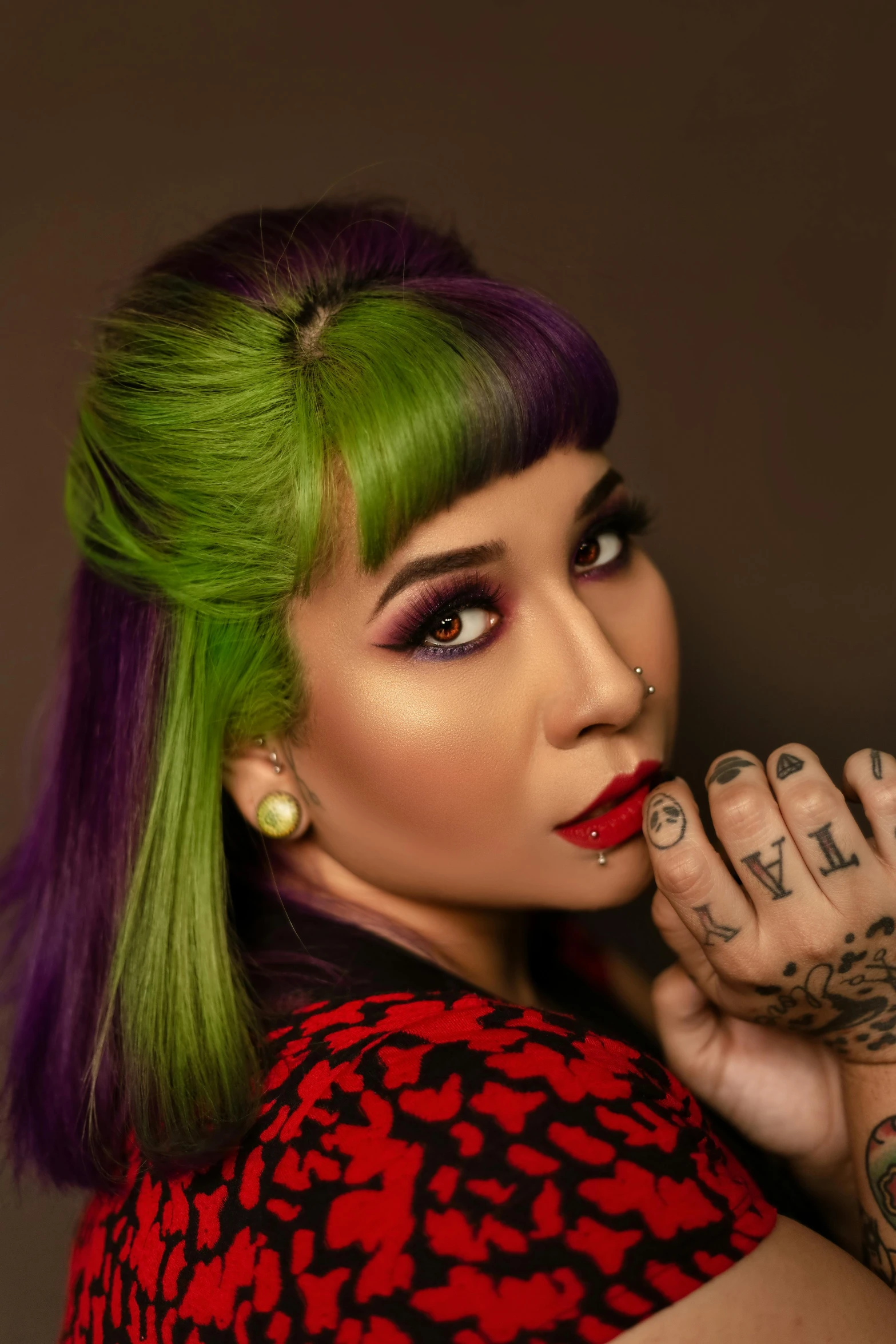 a woman with green hair and tattoos posing for a picture, an album cover, inspired by Julia Pishtar, trending on pexels, pop art, an asian woman, green and purple, ashteroth, stern look