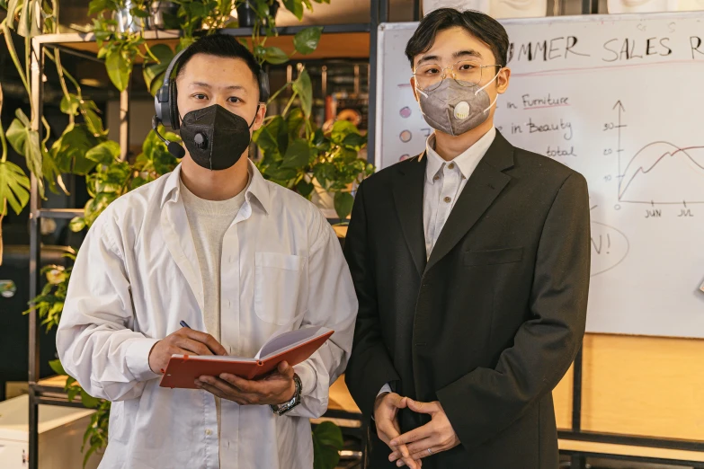 two men standing next to each other in front of a whiteboard, an album cover, by Jang Seung-eop, pexels contest winner, people are wearing masks, japanese akihabara cafe, ai researcher, wearing a botanical gas mask