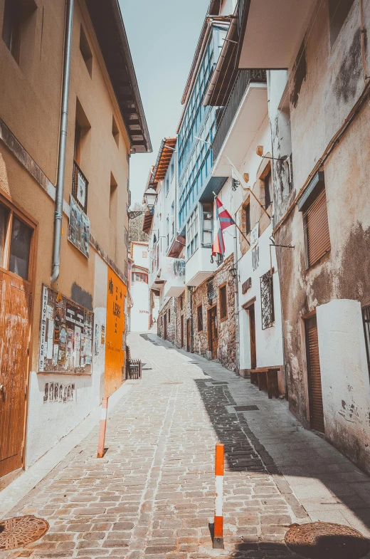 a red fire hydrant sitting on the side of a street, a picture, pexels contest winner, quito school, sunlight and whimsical houses, narrow footpath, gif, city of armenia quindio