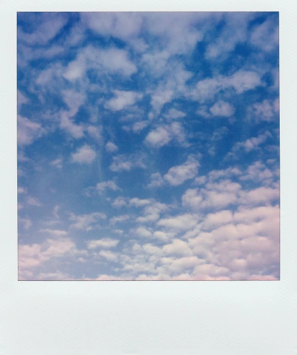 a polaroid picture of a blue sky with clouds, by Nathalie Rattner, unsplash, jen atkin, detailed medium format photo, uniform off - white sky, 27