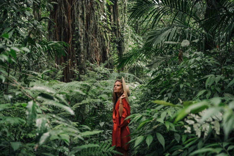 a woman standing in the middle of a forest, a portrait, by Emma Andijewska, sumatraism, lush jungle, red clothes, american astronaut in the forest, avatar image