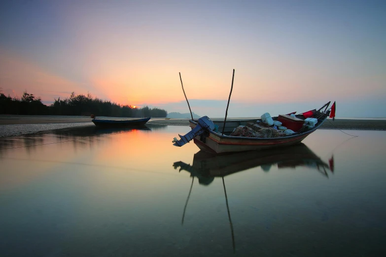 a couple of boats sitting on top of a body of water, by Basuki Abdullah, unsplash contest winner, vietnam, soft glow, photographic print, multicoloured