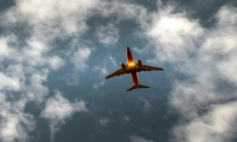 a large jetliner flying through a cloudy sky, by Carey Morris, pexels contest winner, figuration libre, low angle!!!!, beautifully lit, thumbnail, modeled