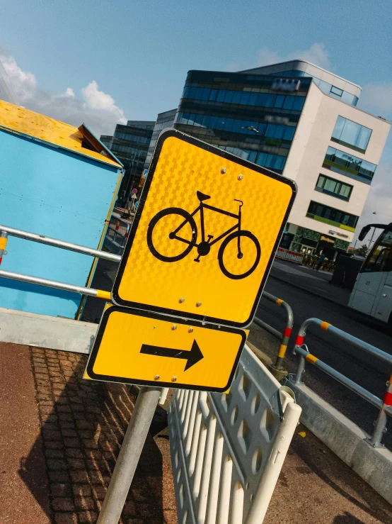 a yellow street sign sitting on the side of a road, a cartoon, unsplash, constructivism, rides a bike, delft, thick squares and large arrows, 🚿🗝📝