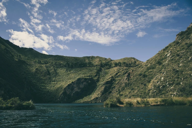 a body of water with a mountain in the background, quechua, picton blue, alessio albi, giant river