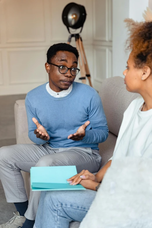 a man and woman sitting on a couch talking to each other, black man, stressing out, man with glasses, clinical