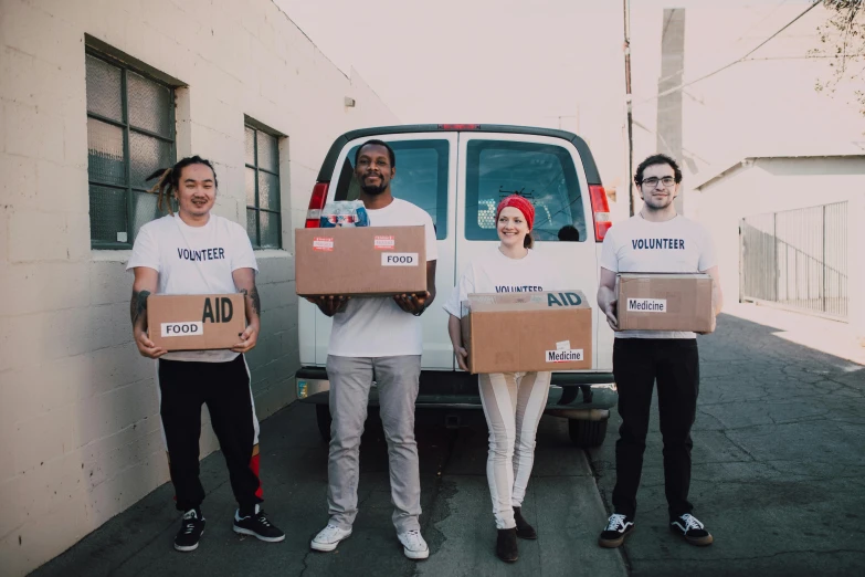 a group of people holding boxes in front of a van, by Francis Helps, los angeles ca, first aid kit, white wearing, avatar image