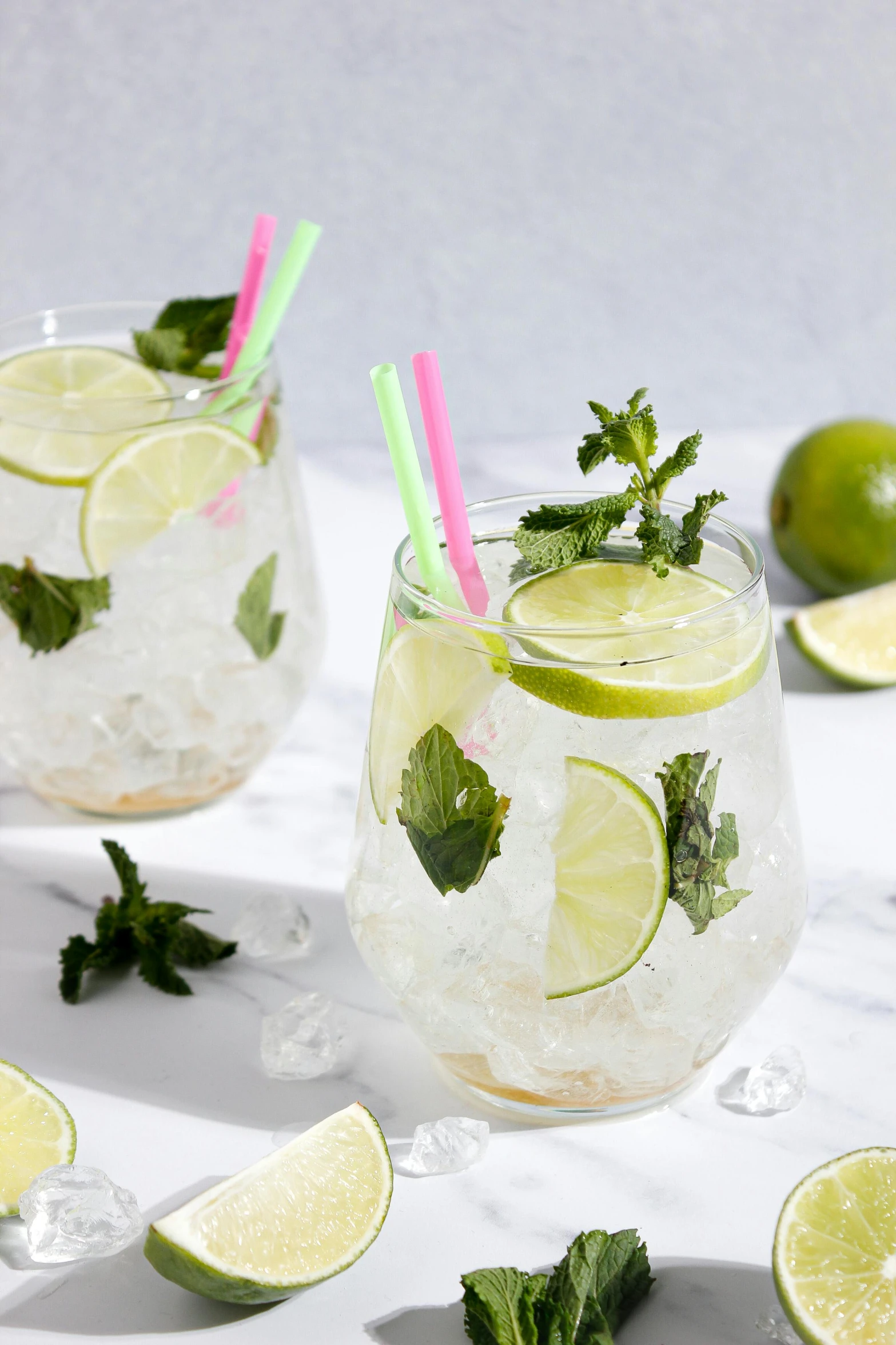 two glasses filled with ice and lime slices, profile image, mint higlights, thumbnail, alternate angle