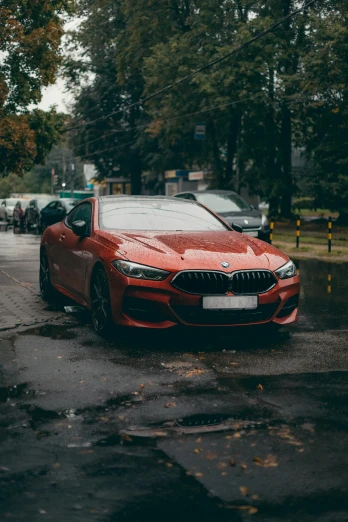 a red bmw parked on the side of a road, by Adam Marczyński, pexels contest winner, wet pavement, square, front, tournament