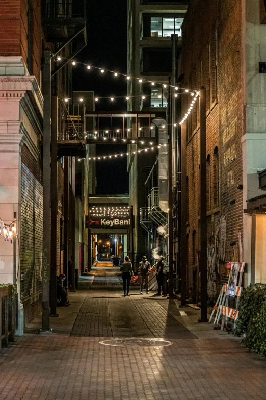 a couple of people that are walking down a street, a digital rendering, by Randall Schmit, unsplash contest winner, taverns nighttime lifestyle, theater access corridor, in an alley, memphis