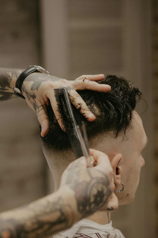 a man getting his hair cut at a barber shop, a tattoo, by Austin English, trending on pexels, hand holding a knife, short hair on top of his head, detailed face and body, high textured