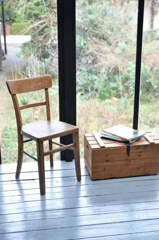 a couple of wooden chairs sitting on top of a wooden floor, inspired by Constantin Hansen, unsplash, arte povera, military storage crate, in karuizawa, next to window, product introduction photo