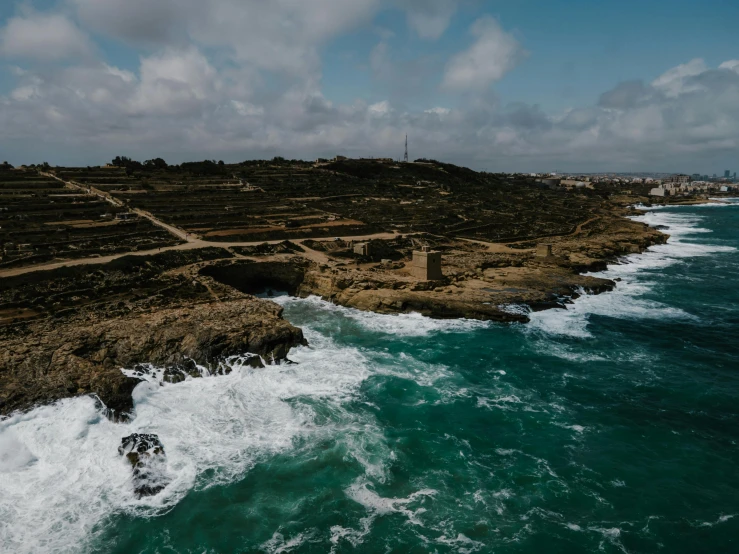 a large body of water next to a rocky shore, pexels contest winner, les nabis, jerez, offshore winds, farming, an eerie whirlpool