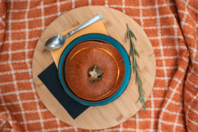 a bowl of soup sitting on top of a wooden cutting board, trending on unsplash, hurufiyya, carriage made of pumpkins, blue and orange, velvet tablecloth, thumbnail