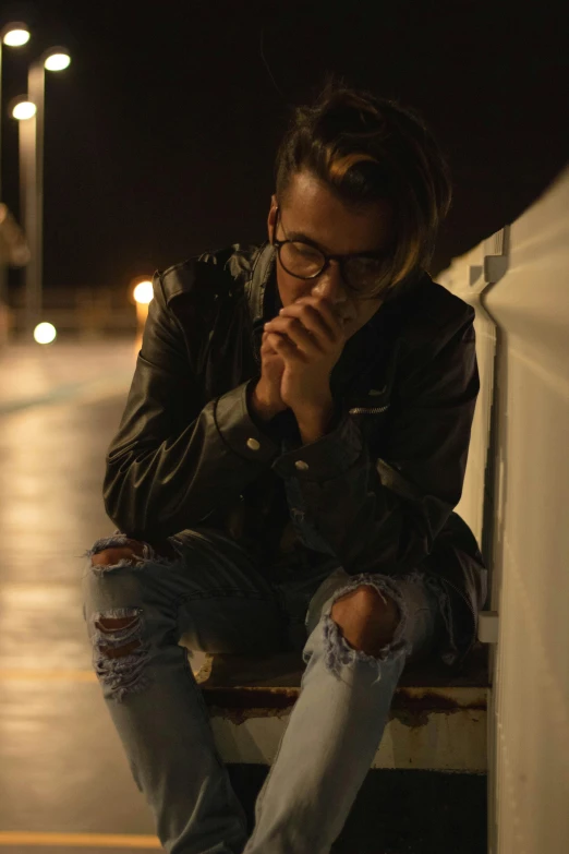 a man sitting on a bench smoking a cigarette, an album cover, trending on pexels, antipodeans, lights in the dark, man with glasses, portrait of depressed teen, androgynous person