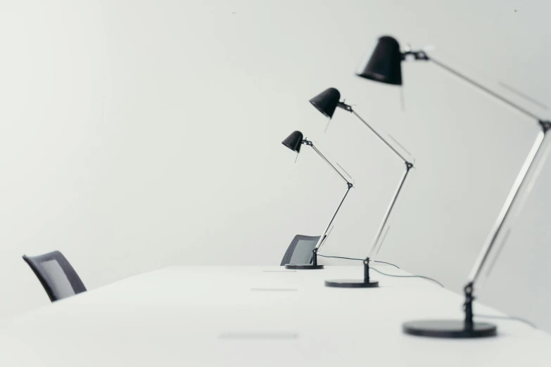 a row of lamps sitting on top of a white table, pexels contest winner, minimalism, computer wallpaper, mostly black, small manufacture, museum lighting