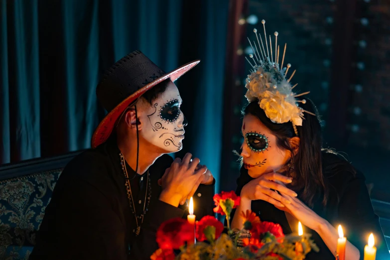 a couple of people sitting at a table with a cake, a portrait, by Julia Pishtar, pexels contest winner, vanitas, dia de los muertos makeup, bouquet, elaborate lights. mask on face, thumbnail
