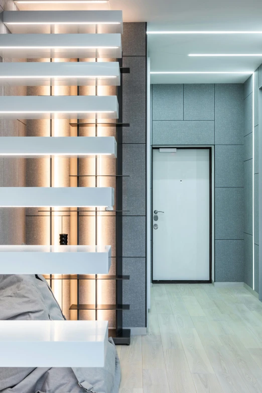 a bed room with a neatly made bed and a staircase, inspired by Reinier Nooms, pexels contest winner, light and space, elevator doors look like a mouth, metallic reflective surfaces, accent lighting : : peugot onyx, apartment hallway