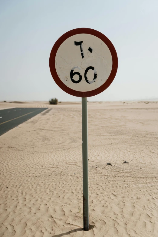 a speed limit sign in the middle of the desert, by Daniel Seghers, no helmet!!!!, near the beach, from the 7 0 s, ameera al-taweel