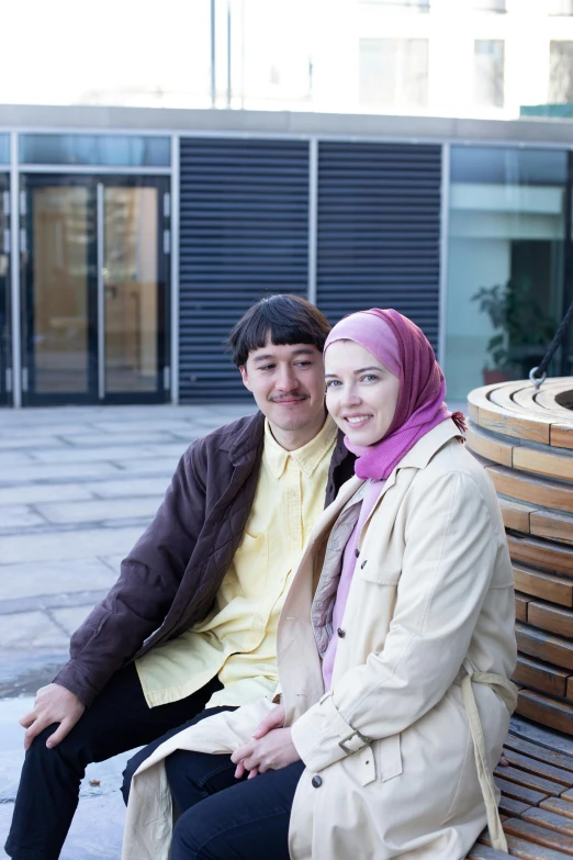 a man and a woman sitting on a bench, hurufiyya, reykjavik junior college, hijab, ruan jia and fenghua zhong, 2 people