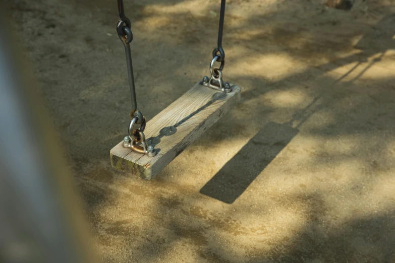 a close up of a child's swing in a playground, unsplash, volumetric shadows, on a wooden plate, 15081959 21121991 01012000 4k, super detailed image