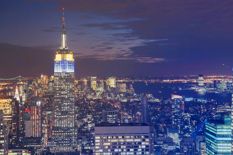 a view of a city at night from the top of a building, pexels contest winner, hudson river school, empire state building, slide show, ad image