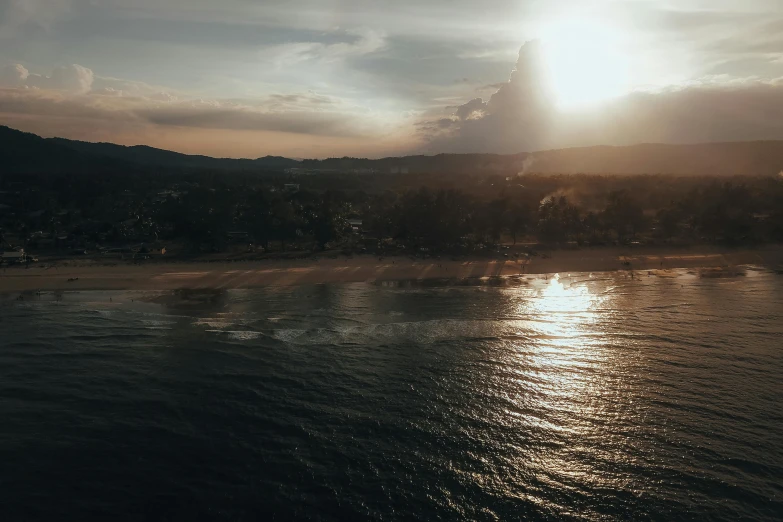 the sun is setting over a body of water, pexels contest winner, aerial perspective, golden hour in boracay, moody light, the city of santa barbara